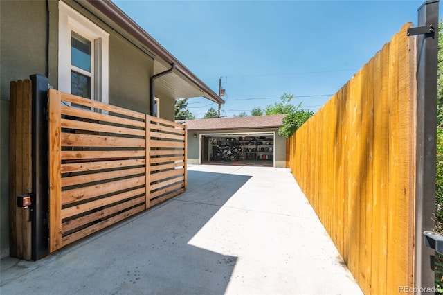 915 N Kearney St, Denver, CO 80220 - view of side of home featuring fence, stucco siding, and a garage
