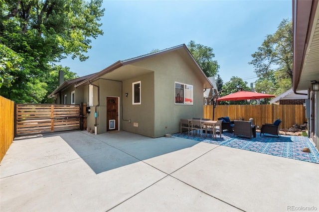 915 N Kearney St, Denver, CO 80220 - back of property with stucco siding, fence, a patio, and outdoor dining space