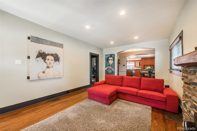 915 N Kearney St, Denver, CO 80220 - living area featuring arched walkways, wood finished floors, recessed lighting, and baseboards