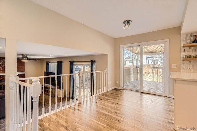 spare room featuring ceiling fan, baseboards, and light wood-style floors