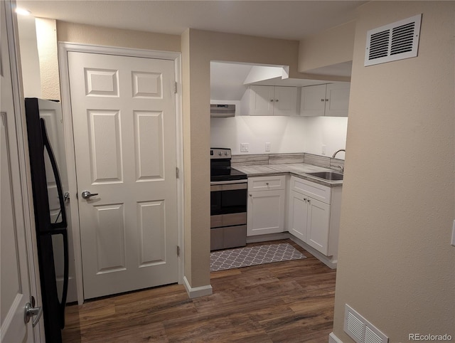 kitchen with light countertops, visible vents, white cabinets, stainless steel range with electric cooktop, and a sink