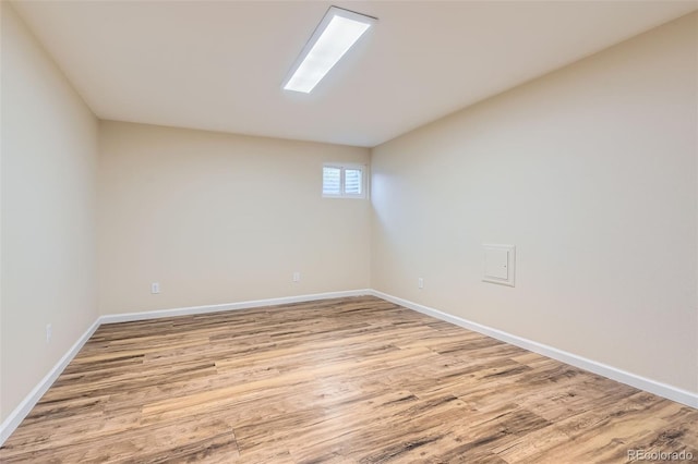 empty room featuring light wood-style flooring and baseboards