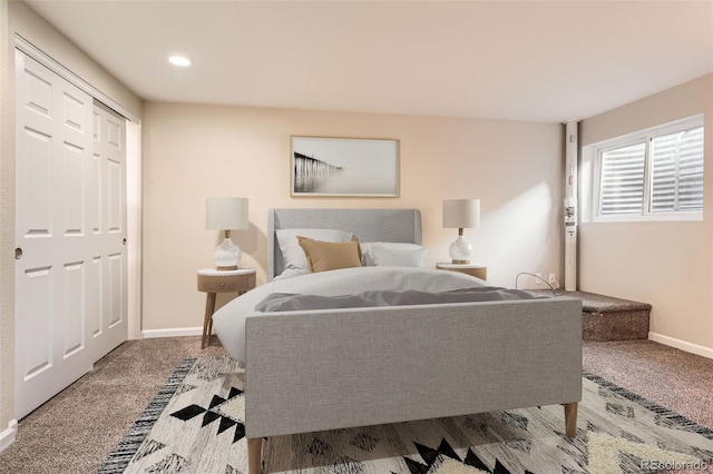 carpeted bedroom featuring baseboards and recessed lighting