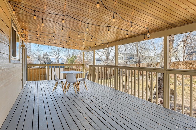 wooden terrace with outdoor dining space