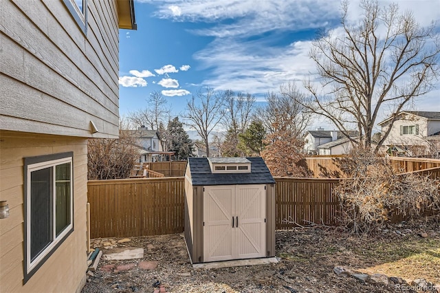 view of shed featuring a fenced backyard and a residential view