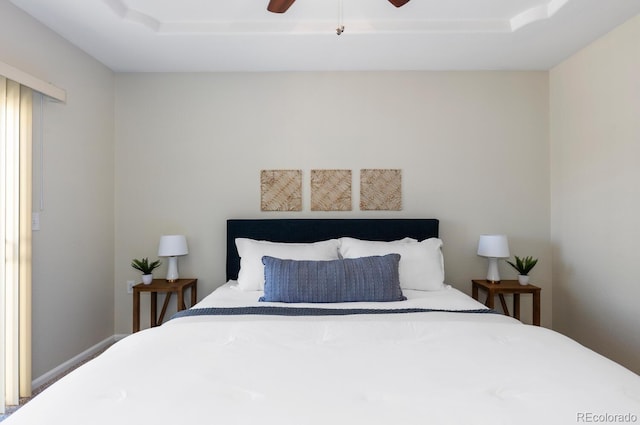 bedroom featuring ceiling fan and a tray ceiling