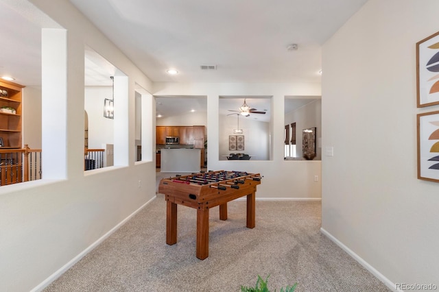 rec room featuring ceiling fan and light colored carpet