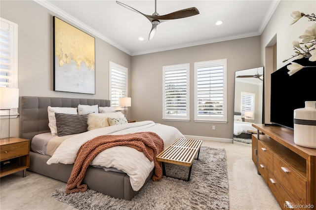 carpeted bedroom featuring crown molding and ceiling fan