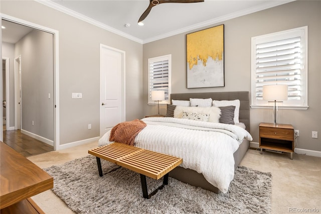 bedroom featuring ornamental molding, light colored carpet, and ceiling fan