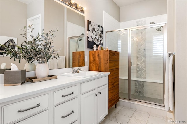 bathroom featuring walk in shower and vanity