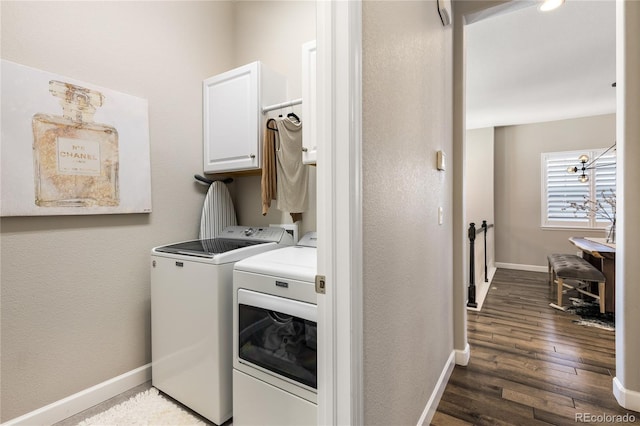 washroom featuring cabinets, dark hardwood / wood-style flooring, and washing machine and dryer