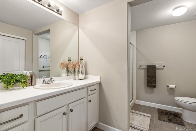 bathroom featuring a shower with door, vanity, tile patterned floors, and toilet