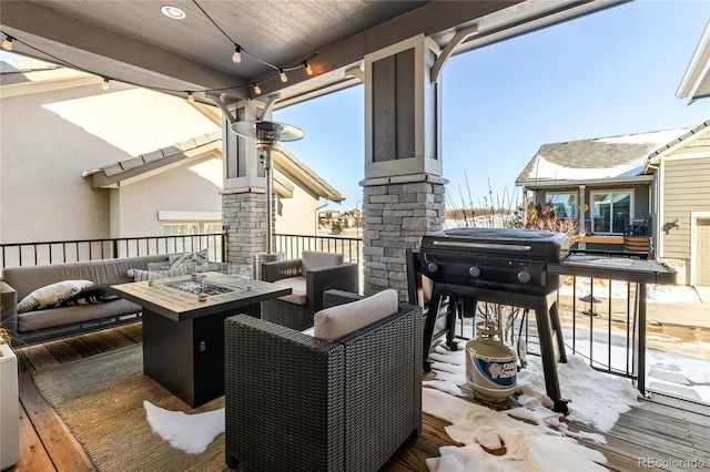 wooden deck featuring an outdoor fire pit