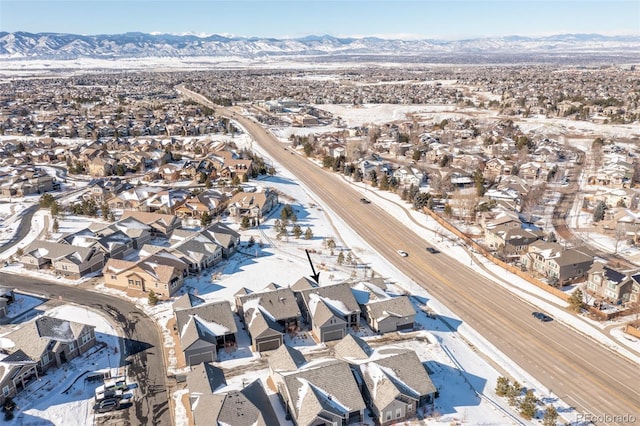 snowy aerial view with a mountain view