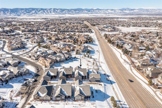 snowy aerial view featuring a mountain view