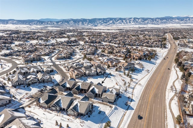 snowy aerial view with a mountain view