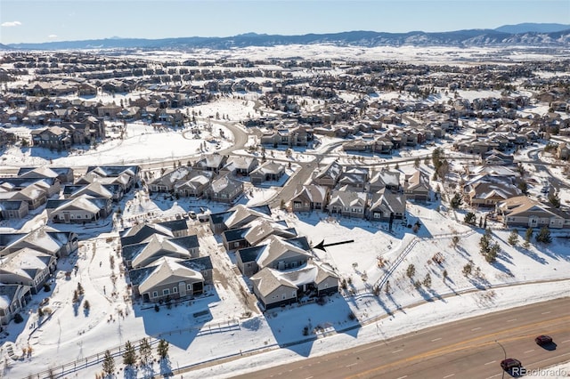 snowy aerial view with a mountain view