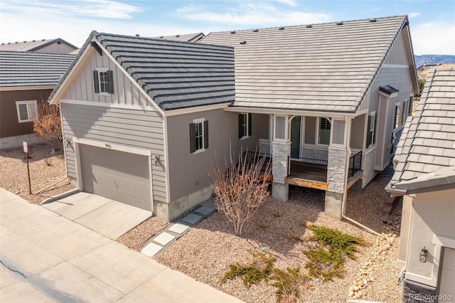 view of front of home with a porch, an attached garage, concrete driveway, and board and batten siding