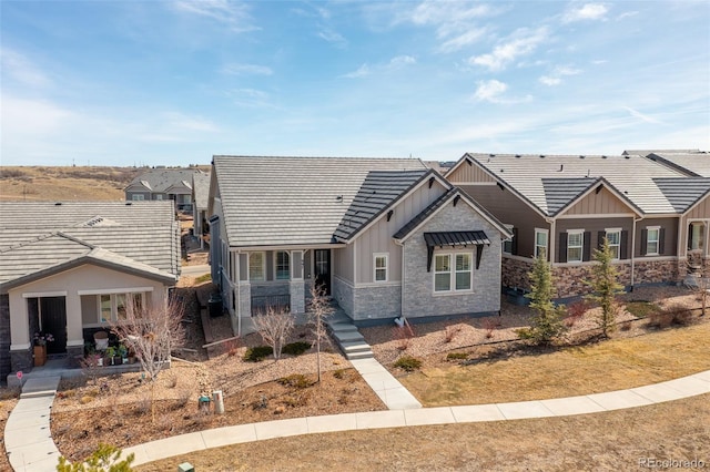 craftsman-style home with board and batten siding and stone siding