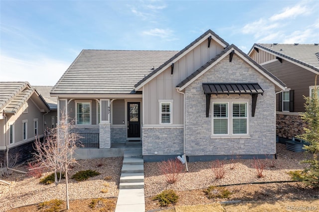 craftsman house featuring a porch, board and batten siding, and stone siding