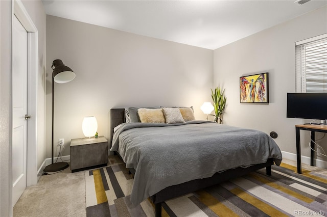 bedroom with visible vents, baseboards, and light carpet