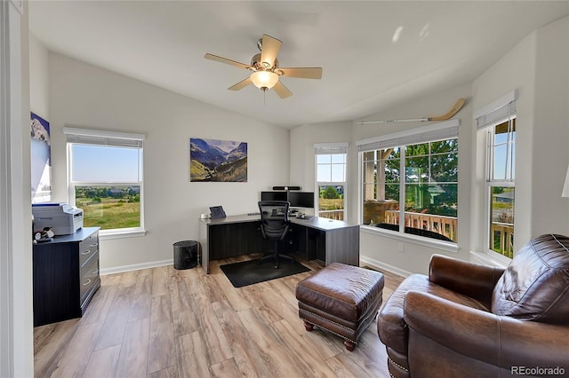 office space with light wood finished floors, baseboards, a wealth of natural light, and vaulted ceiling