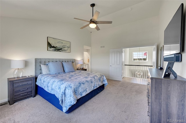 bedroom with baseboards, visible vents, high vaulted ceiling, ceiling fan, and light carpet