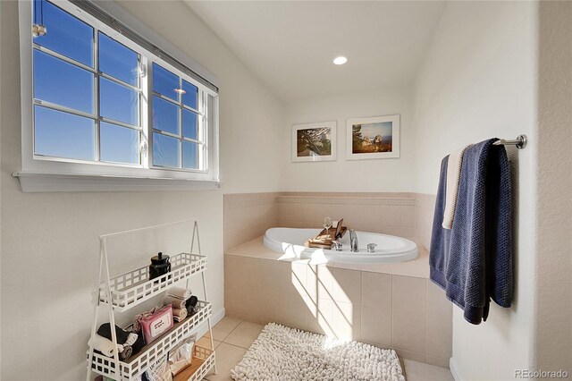 bathroom with tile patterned flooring and a garden tub