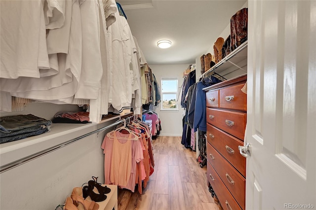 spacious closet featuring light wood-style flooring