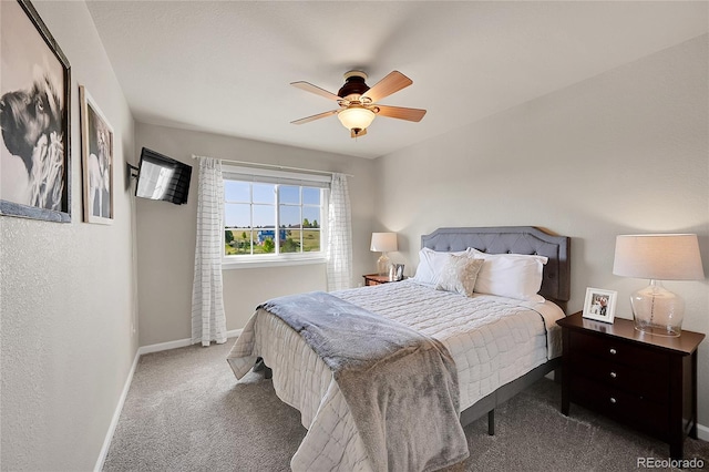 carpeted bedroom featuring baseboards and a ceiling fan