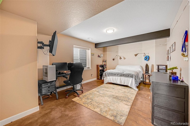 bedroom featuring baseboards, concrete flooring, and a textured ceiling