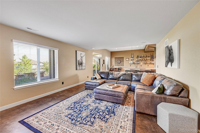 living room featuring baseboards and visible vents