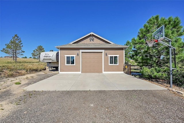 exterior space featuring concrete driveway and a garage