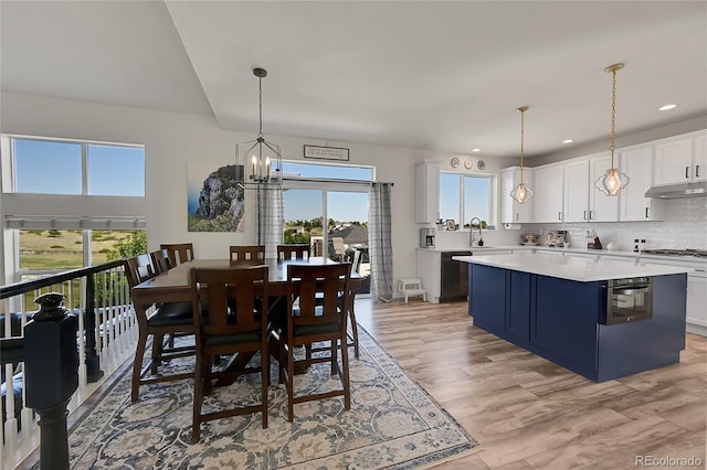 dining space featuring recessed lighting, a notable chandelier, a healthy amount of sunlight, and light wood-type flooring