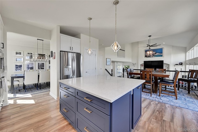 kitchen featuring white cabinetry, light countertops, stainless steel refrigerator with ice dispenser, and light wood-type flooring