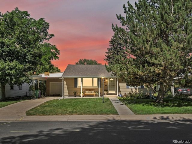 1827 S Fairfax St, Denver, CO 80222 - view of front of house featuring concrete driveway, a front yard, an attached carport, an attached garage, and outdoor lounge area