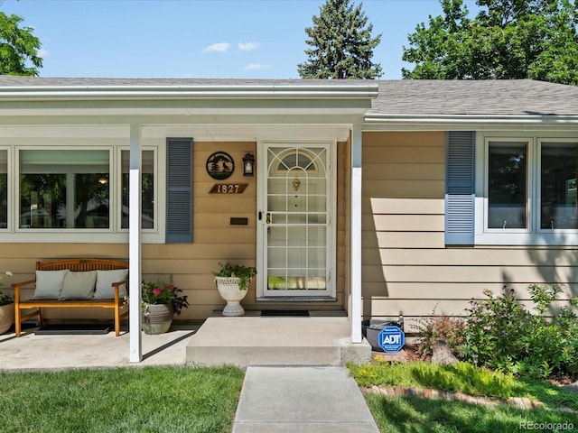 1827 S Fairfax St, Denver, CO 80222 - doorway to property featuring roof with shingles and a porch