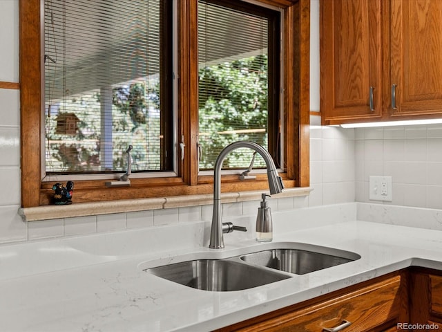 1827 S Fairfax St, Denver, CO 80222 - kitchen featuring backsplash, brown cabinetry, and plenty of natural light