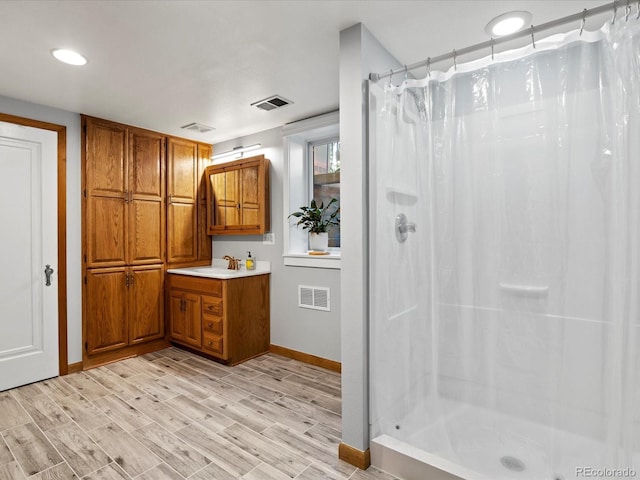 1827 S Fairfax St, Denver, CO 80222 - full bath featuring vanity, a shower with shower curtain, and wood finished floors