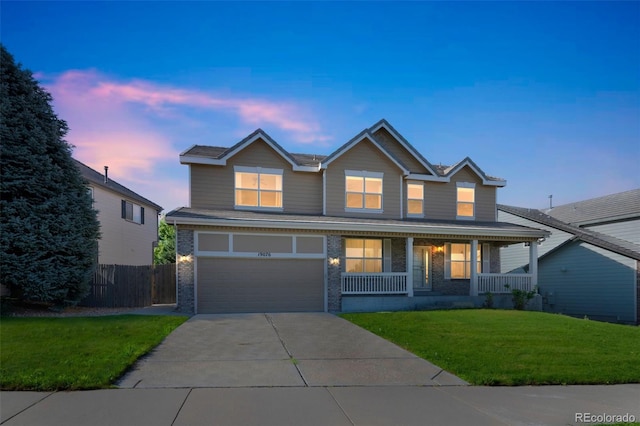 19076 E Lasalle Pl, Aurora, CO 80013 - traditional home featuring a porch, driveway, a garage, and brick siding