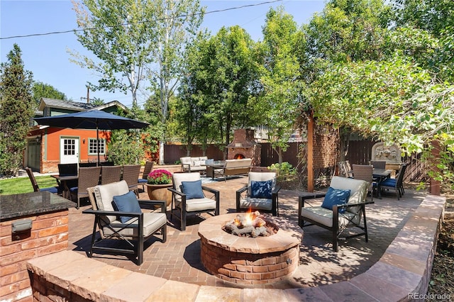 view of patio / terrace with an outdoor living space with a fire pit