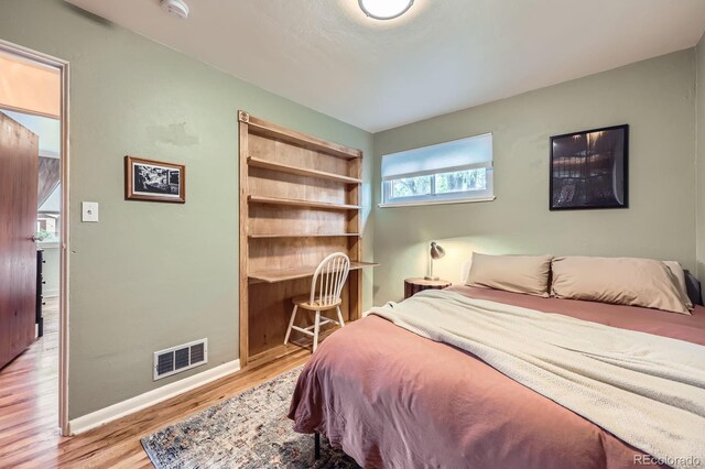 6995 W 27th Ave, Wheat Ridge, CO 80033 - bedroom featuring light wood-style flooring and baseboards