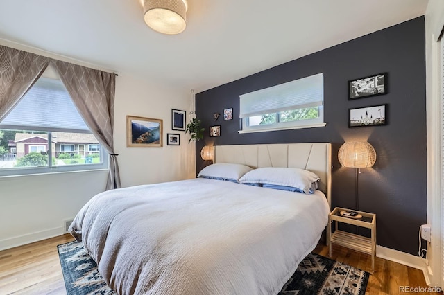 6995 W 27th Ave, Wheat Ridge, CO 80033 - bedroom with wood finished floors and an accent wall