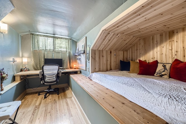 6995 W 27th Ave, Wheat Ridge, CO 80033 - bedroom with lofted ceiling, wood finished floors, an office area, and wood walls