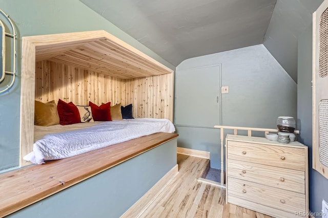 6995 W 27th Ave, Wheat Ridge, CO 80033 - bedroom with vaulted ceiling, wood finished floors, and wood walls