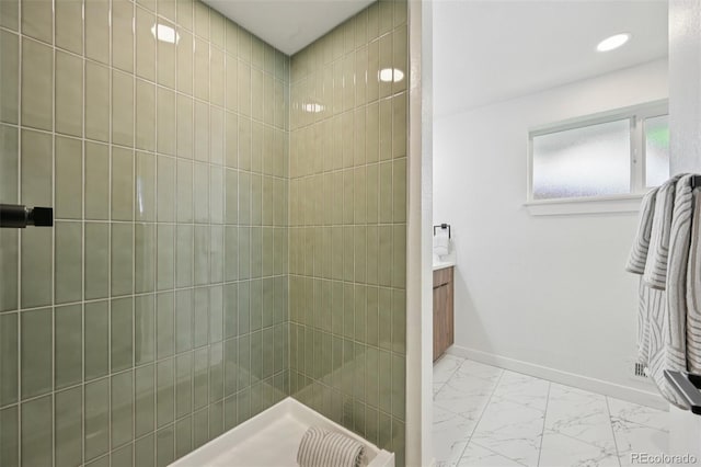 169 Yates St, Denver, CO 80219 - bathroom featuring marble finish floors, vanity, and a tile shower