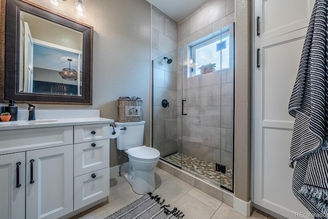 31455 Half Peak Trl, Pine, CO 80470 - full bath featuring toilet, vanity, a stall shower, tile patterned floors, and baseboards