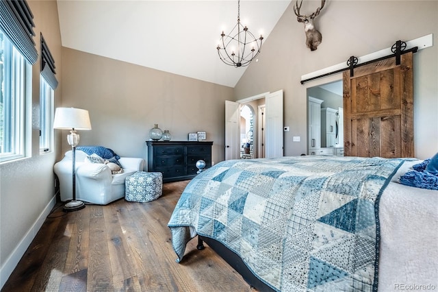 31455 Half Peak Trl, Pine, CO 80470 - bedroom featuring a barn door, wood finished floors, baseboards, a chandelier, and high vaulted ceiling