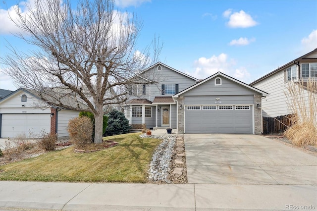 view of front facade featuring a front yard, concrete driveway, an attached garage, and fence