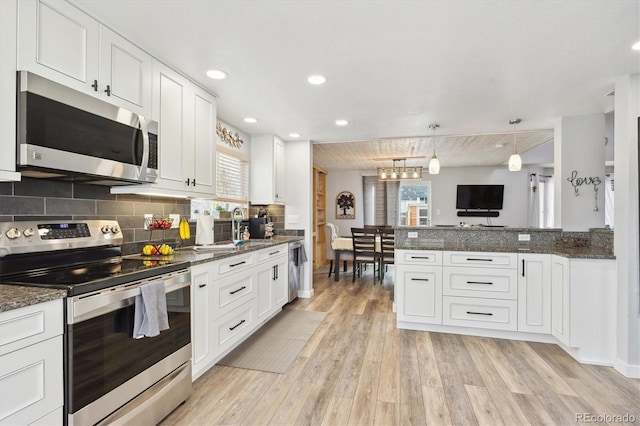 kitchen featuring white cabinets, plenty of natural light, and appliances with stainless steel finishes